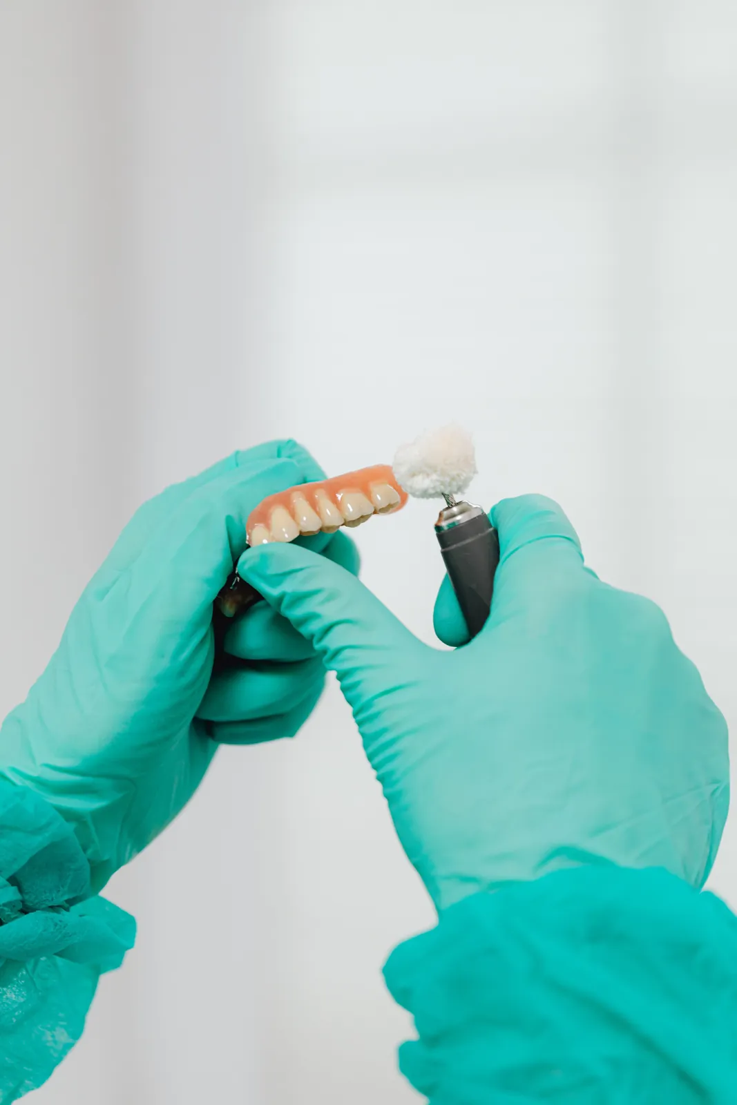 A denture being polished by hand