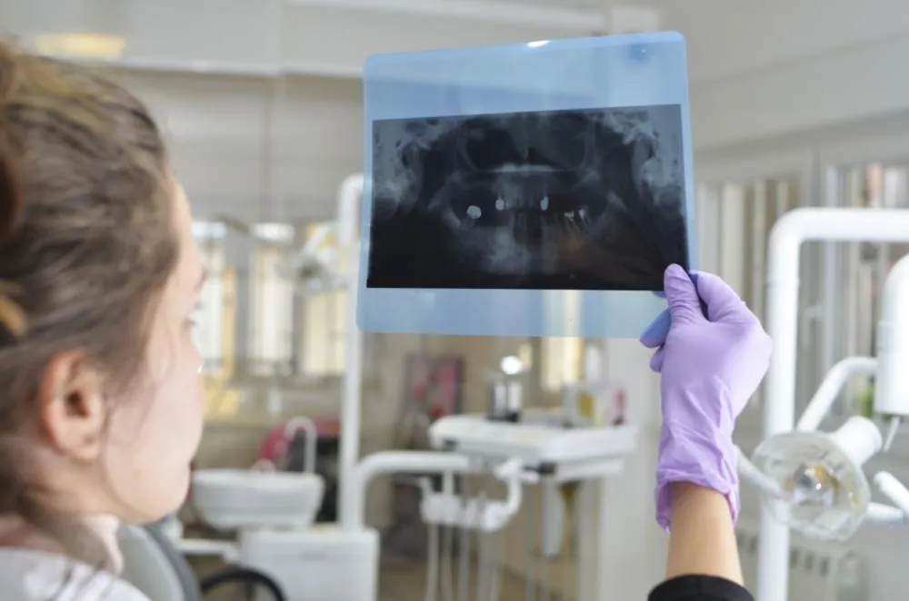 Dental professional reviewing an X-ray