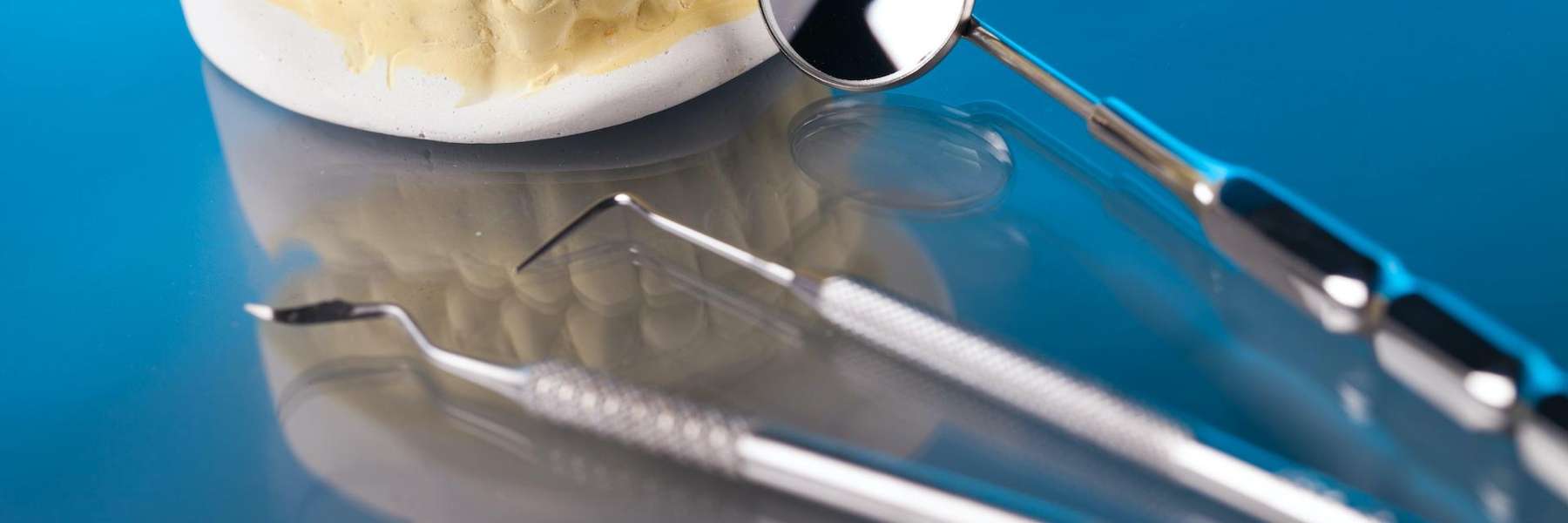 A picture of a dental crown and teeth extraction tools in Elk Grove village