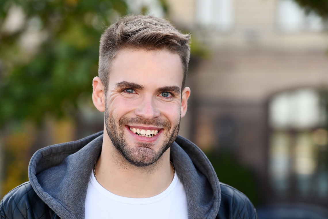 A dentist warmly talking with a patient in a clean dental clinic.
