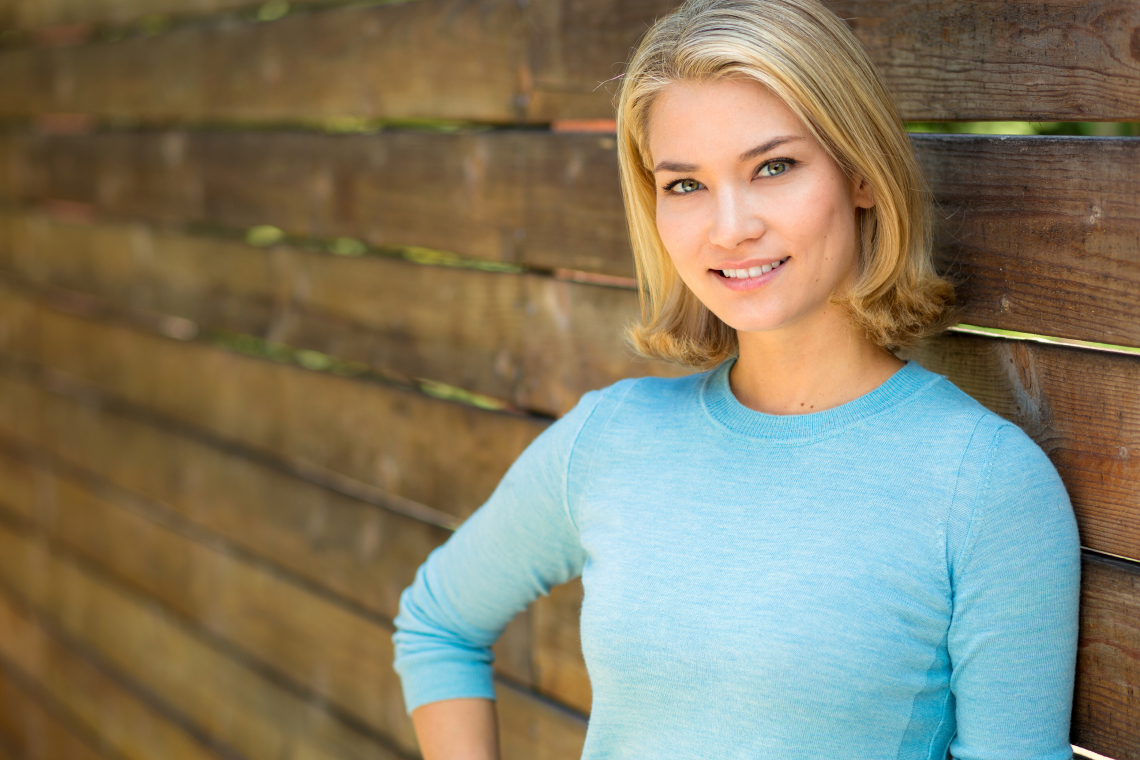 A dentist and patient talking in a modern dental clinic during a consultation.