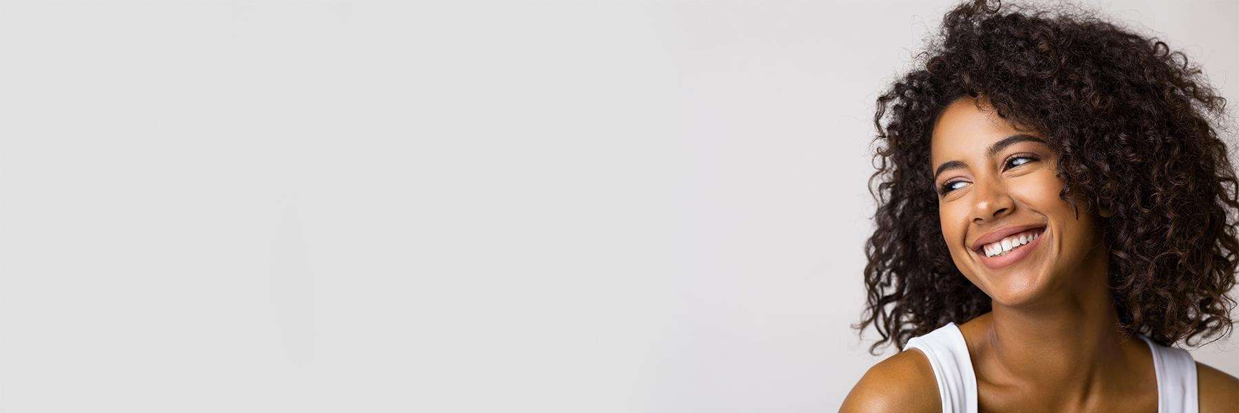 Lady smiling after getting dental crowns in Elk Grove village, Illinois