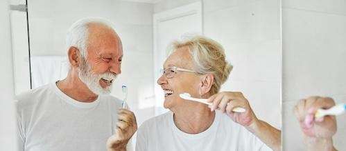 an elderly couple smiling after getting a Gum Disease treatment in Elk Grove Village, IL